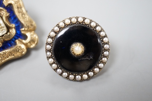 A Victorian yellow metal overlaid and blue enamel set mourning brooch, 31mm and one other seed pearl set mourning brooch.